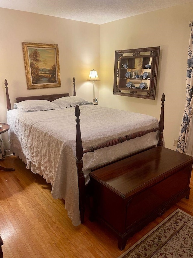 bedroom with hardwood / wood-style flooring and a textured ceiling