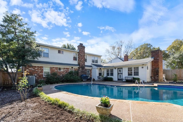 view of pool featuring a patio and central AC