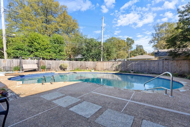 view of swimming pool featuring a patio area, a fenced backyard, and a fenced in pool