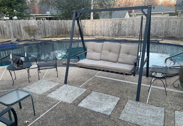 view of swimming pool featuring a fenced in pool, a patio area, and a fenced backyard