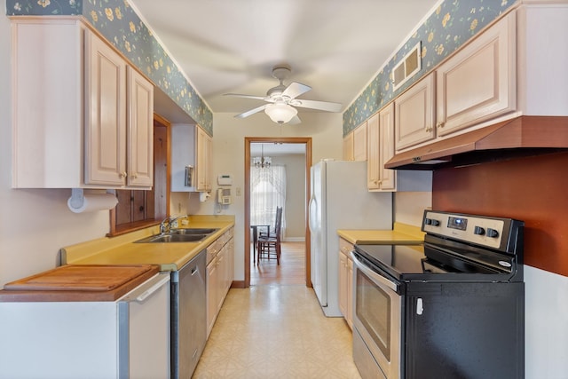 kitchen with under cabinet range hood, a sink, visible vents, appliances with stainless steel finishes, and light floors