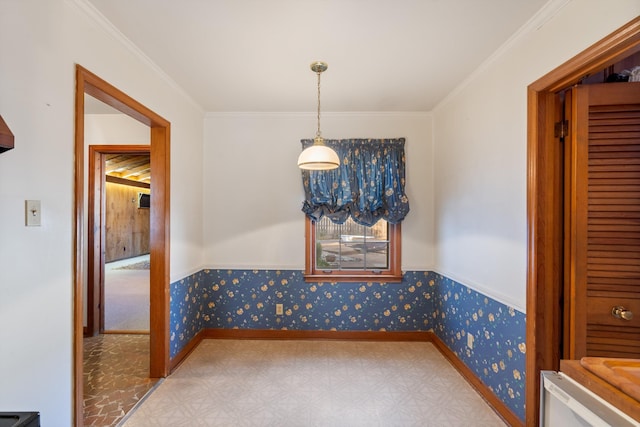 unfurnished dining area with crown molding, baseboards, and wallpapered walls