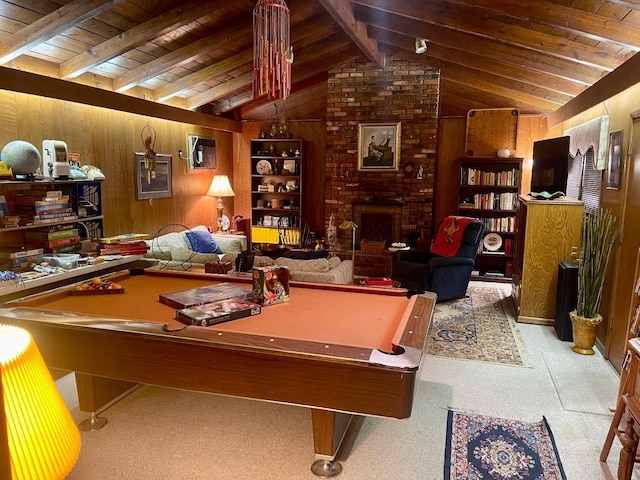 rec room with pool table, lofted ceiling with beams, a brick fireplace, wood walls, and wooden ceiling