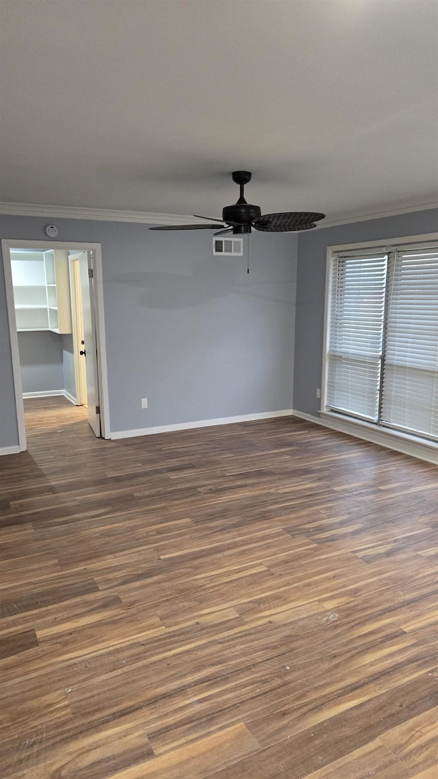 unfurnished room with crown molding, ceiling fan, and dark hardwood / wood-style flooring