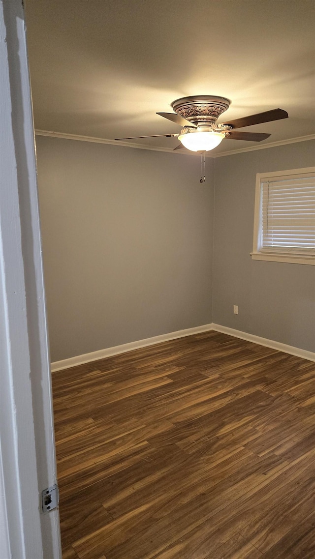 unfurnished room featuring ceiling fan, ornamental molding, and dark hardwood / wood-style floors