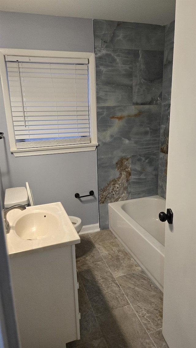 full bathroom featuring vanity, bathtub / shower combination, and toilet