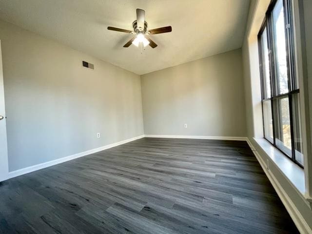 empty room featuring dark hardwood / wood-style floors and ceiling fan