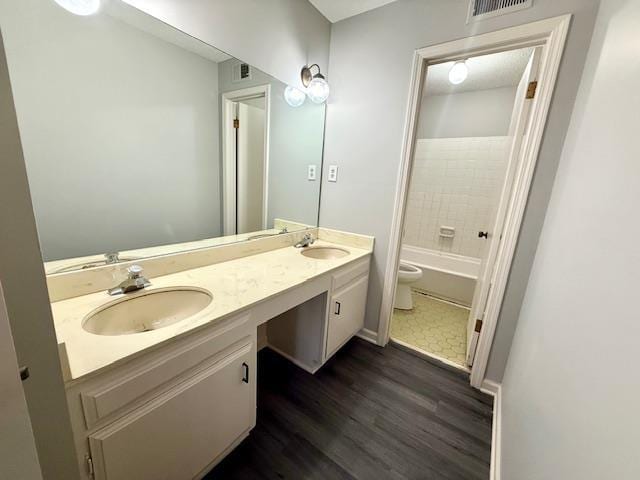 full bathroom featuring hardwood / wood-style flooring, vanity, shower / bathing tub combination, and toilet