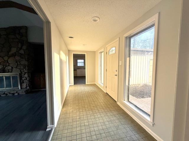 hall with a textured ceiling