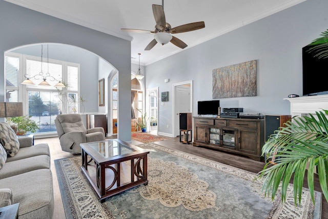 living room featuring crown molding, ceiling fan, and dark wood-type flooring