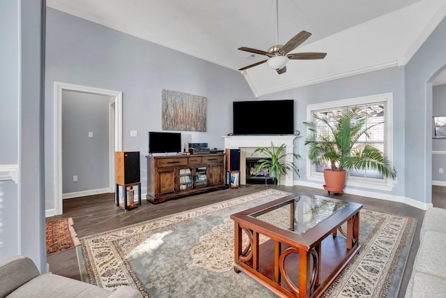 living room featuring vaulted ceiling, ornamental molding, and ceiling fan