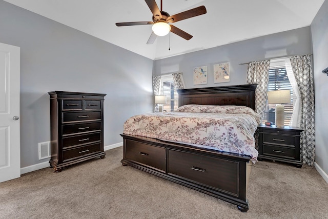 bedroom featuring multiple windows, ceiling fan, and light carpet