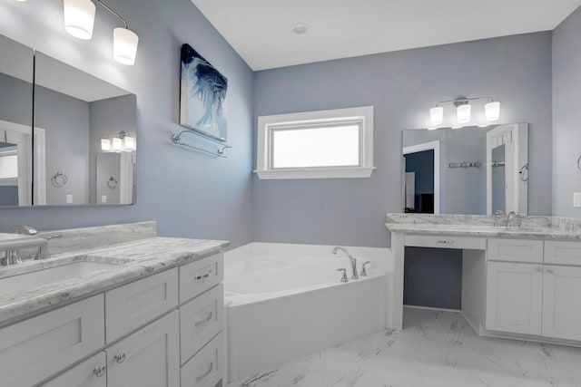 bathroom with vanity and a bath