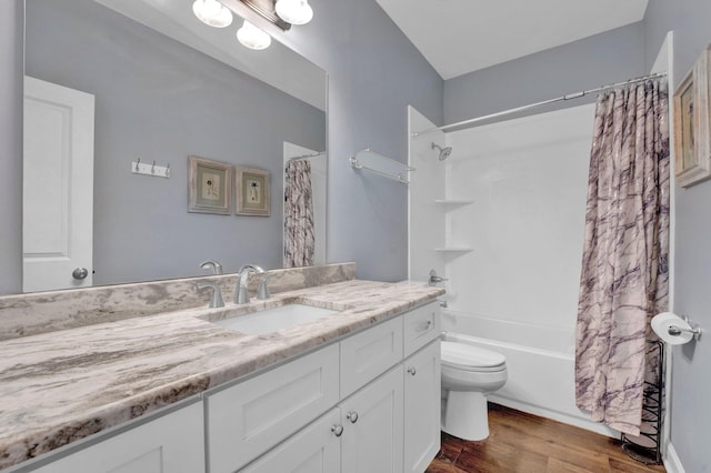 full bathroom with vanity, hardwood / wood-style flooring, toilet, and shower / bathtub combination with curtain