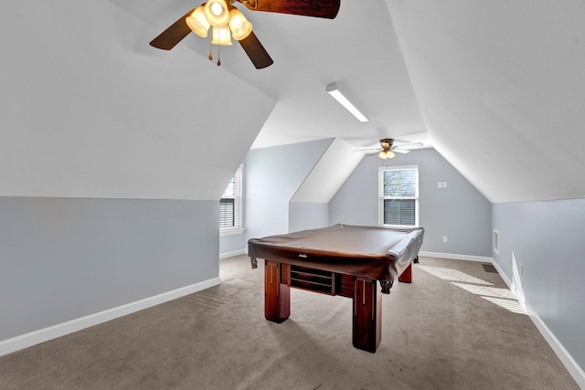 playroom featuring light colored carpet, vaulted ceiling, and a wealth of natural light