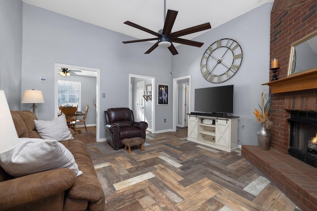 living room with ceiling fan, dark parquet flooring, a fireplace, and high vaulted ceiling