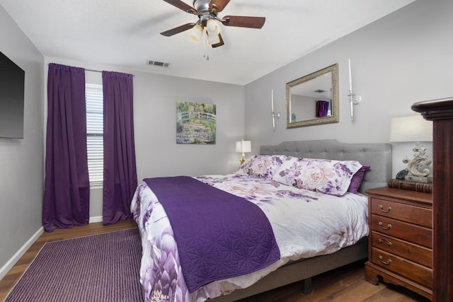 bedroom with ceiling fan and dark hardwood / wood-style flooring