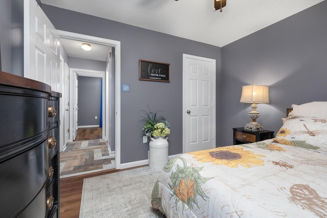 bedroom featuring wood-type flooring and ceiling fan