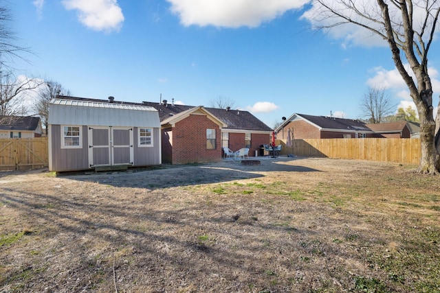 back of property featuring a shed