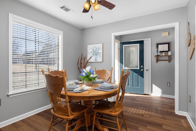 dining room featuring dark hardwood / wood-style floors, a textured ceiling, and ceiling fan