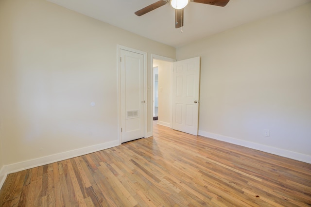 empty room featuring ceiling fan and light hardwood / wood-style flooring