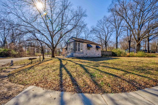 view of side of property featuring a lawn