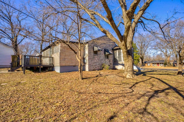 view of property exterior with a deck