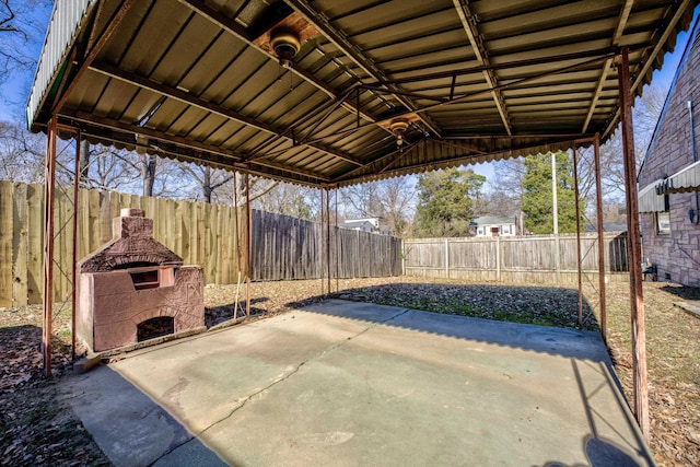 view of patio / terrace featuring an outdoor stone fireplace