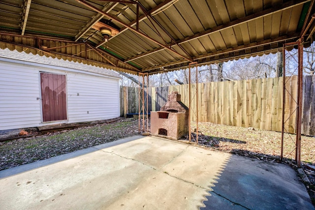 view of patio featuring a fireplace