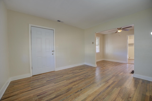 spare room with ceiling fan and dark hardwood / wood-style flooring