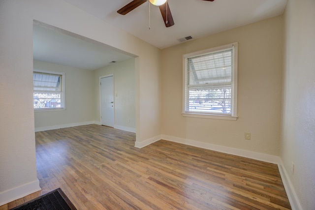 spare room featuring hardwood / wood-style floors and ceiling fan