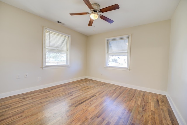 unfurnished room with ceiling fan and light wood-type flooring