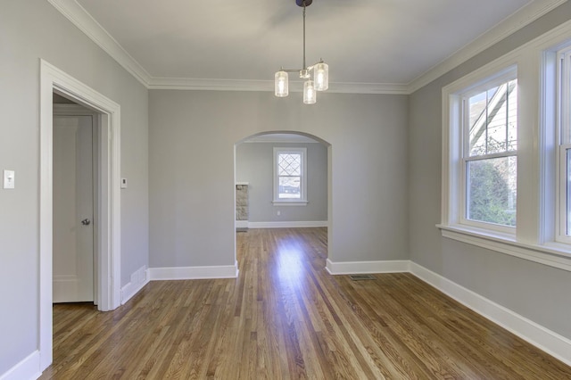 unfurnished dining area with hardwood / wood-style flooring, plenty of natural light, and crown molding