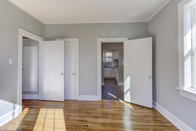 unfurnished bedroom featuring hardwood / wood-style flooring and a closet