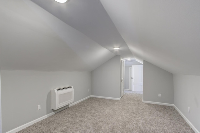 bonus room with light colored carpet, vaulted ceiling, and heating unit