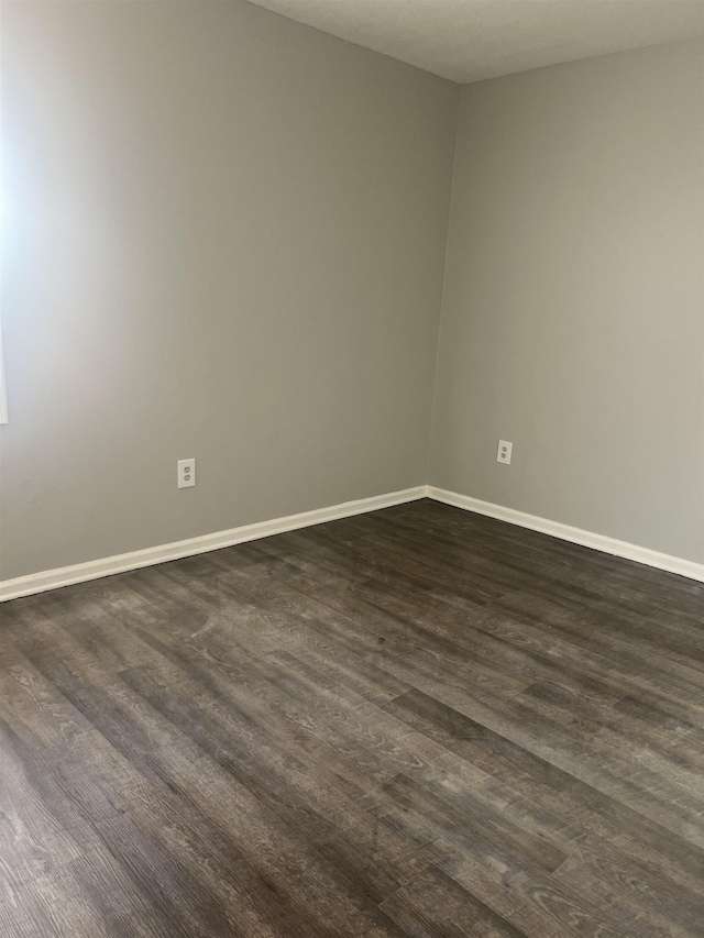 unfurnished room with dark hardwood / wood-style floors