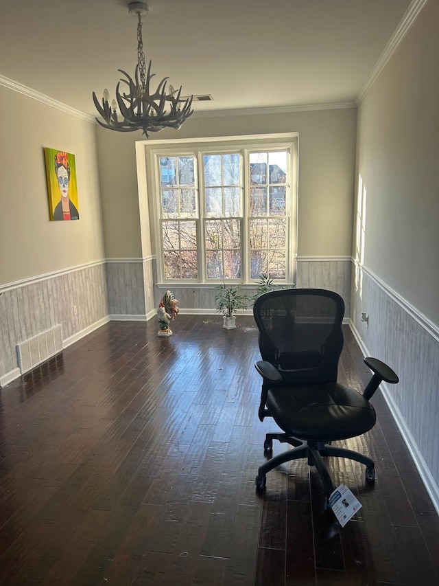 sitting room with visible vents, a wainscoted wall, dark wood-type flooring, crown molding, and a notable chandelier