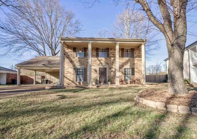 view of front of home with a carport and a front lawn