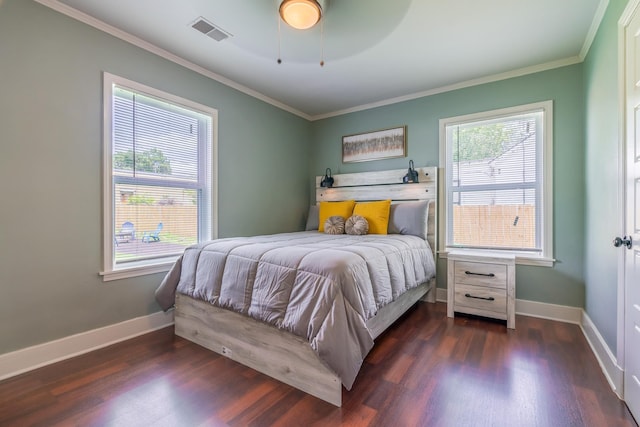 bedroom featuring multiple windows, ornamental molding, and ceiling fan