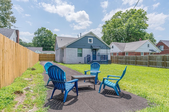 rear view of property featuring a yard