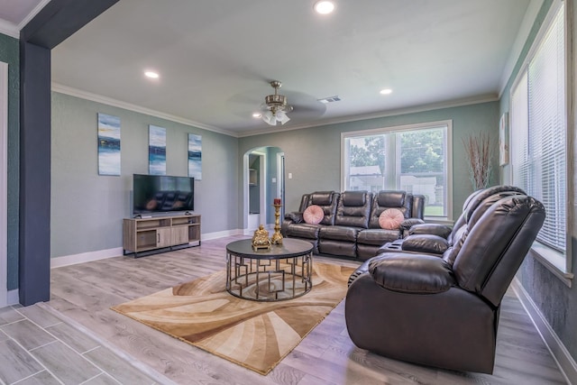 living room featuring crown molding, light hardwood / wood-style floors, and ceiling fan