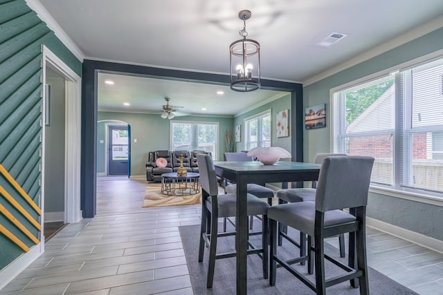 dining area with ornamental molding and a chandelier