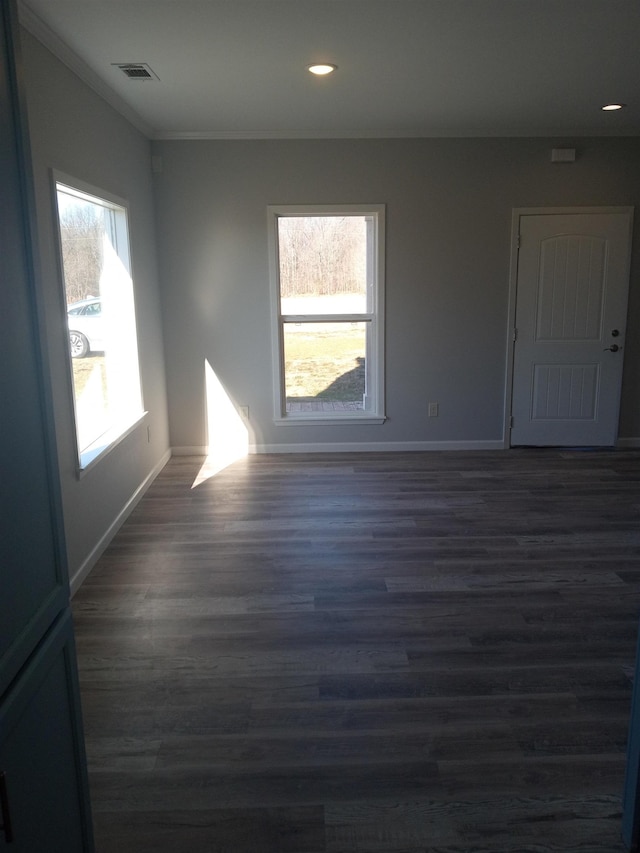 unfurnished room with dark wood-type flooring and ornamental molding