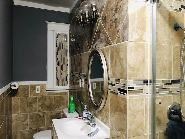 bathroom featuring vanity, toilet, and tiled shower