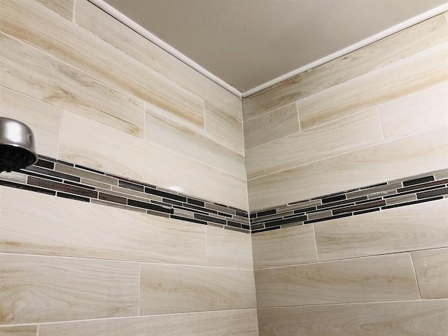 interior details featuring tiled shower