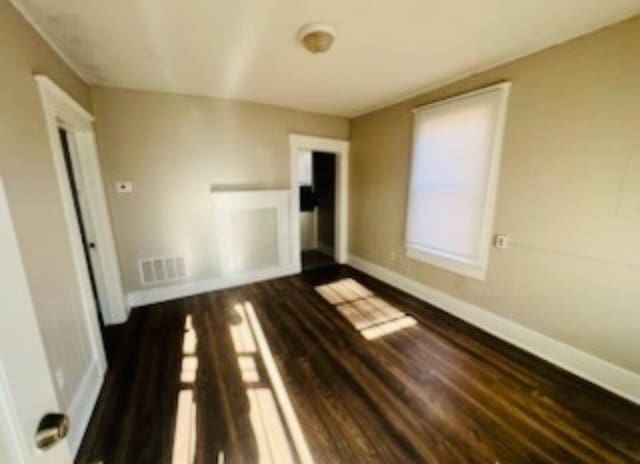 spare room with dark wood-type flooring