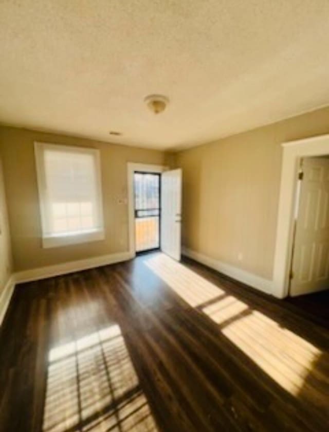 empty room with dark wood-type flooring