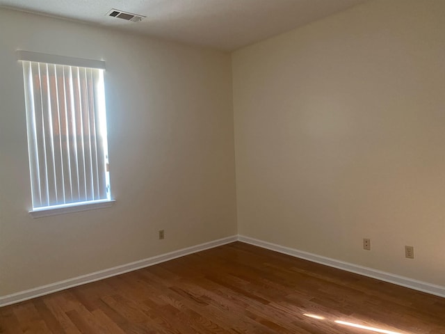 empty room with dark wood-type flooring