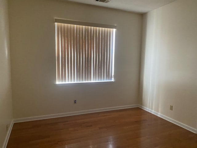 spare room with dark wood-type flooring