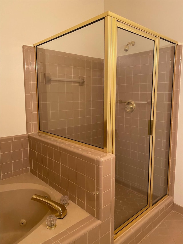 bathroom featuring plus walk in shower and tile patterned flooring